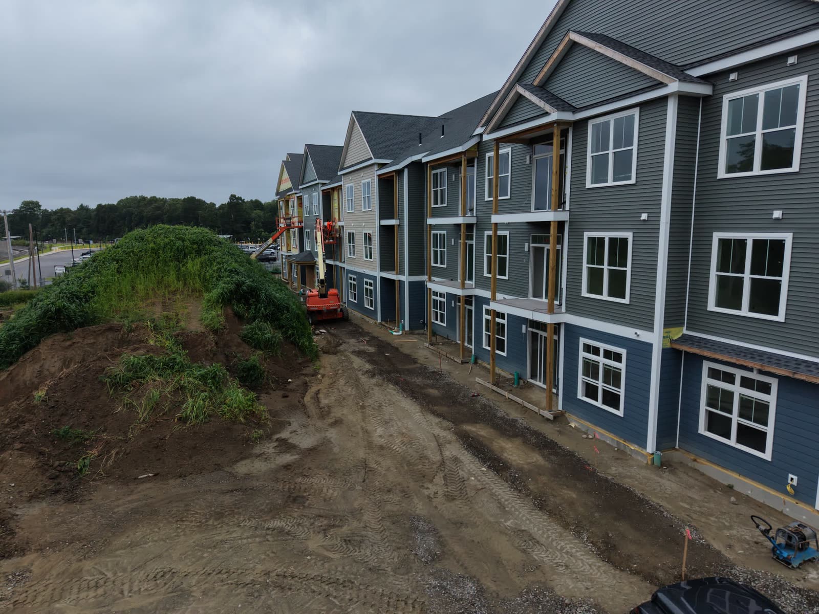 Aerial view of a multifamily building with siding install in progress