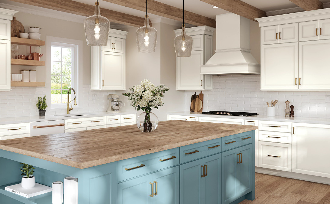 Coastal-farmhouse kitchen with a white shaker perimeter, a decorative painted hood and white tile, centred on a teal island with a thick wood-toned top and an open shelf end