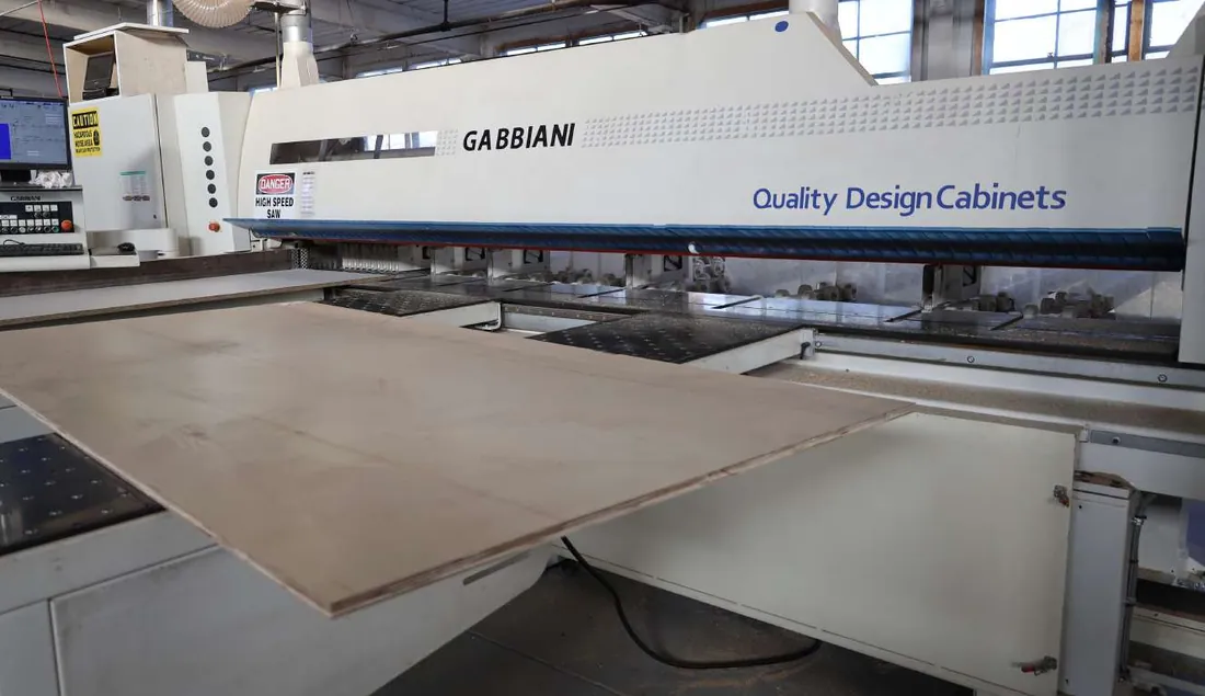 Panel saw carrying the Quality Design Cabinets name on the production floor